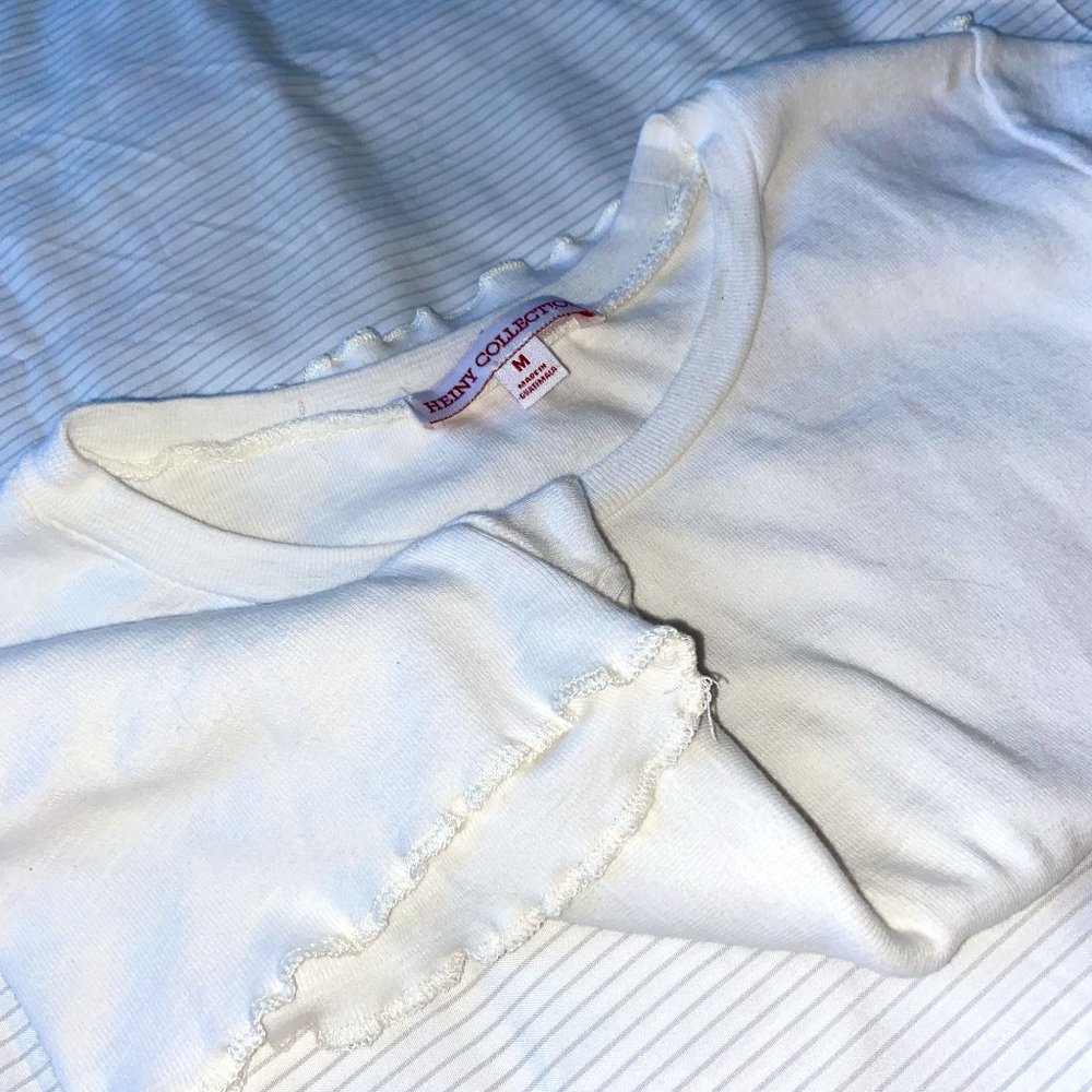 White top with softly ruffled ends